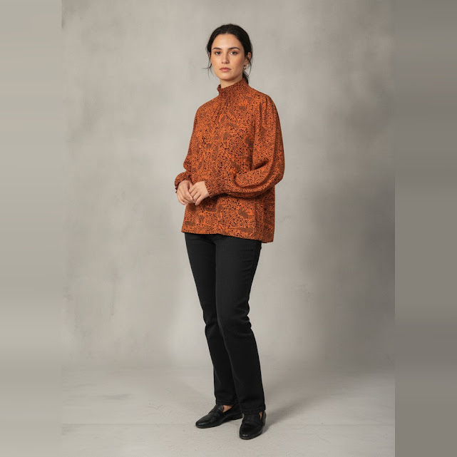 [0037004] Blusa manga larga naranja y negro Animal print talle G Engomado en el cuello y puños